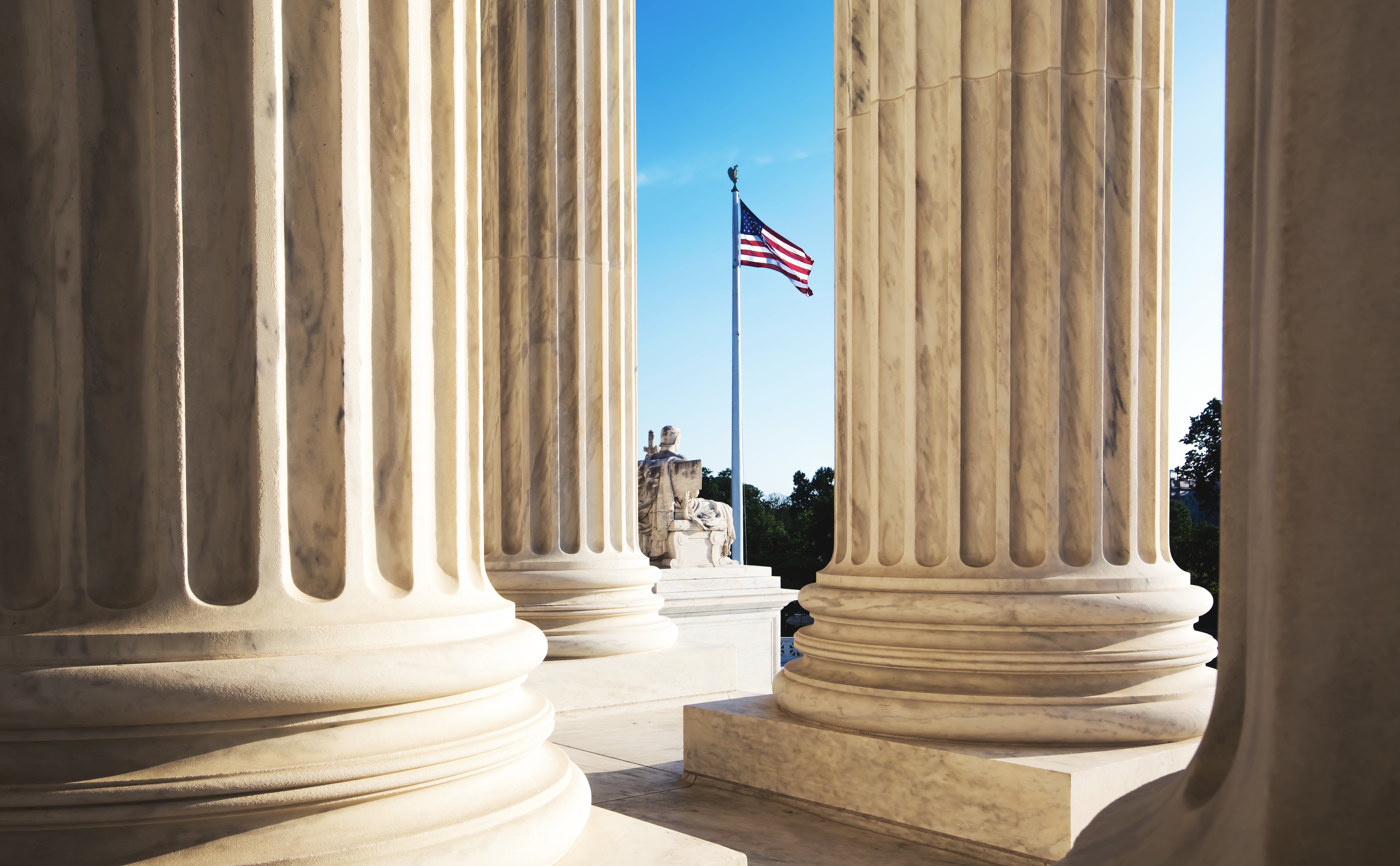 US Supreme Court exterior columns and flag